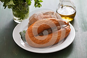 Typical portuguese sausage Farinheira with bread on white plate  on green background photo