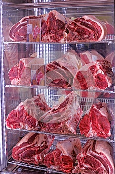 Raw dry aged Bistecca Alla Fiorentina, T-Bone or Porterhouse Steak at the entrance of a restaurant in Florence, Italy photo