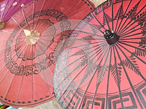 Typical red decorated Burmese monks umbrellas