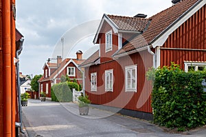 Typical red Swedish wooden houses line the streets of the historic city center of downtown Trosa