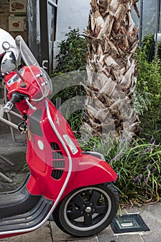 Typical red Vespa  in Sirmione Italy.