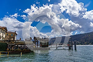 a typical restaurant on a pier of a village on the shores of Lake Maggiore on a spring day