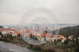 Typical roofs in Prague. Top view - roofs with red tiles in old buildings in Prague. Europe. Empty benches stand in a
