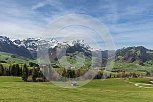 Typical rural landscape in the Appenzell region in Switzerland, view to the snow-capped Alpstein mountains with Saentis