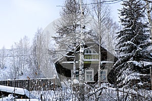 Typical russian abandoned snow-covered village in winter day