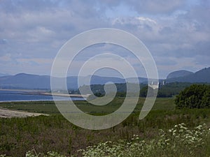 Typical Scottish Highlands landscape with castle and mountains