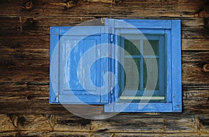 Typical serbian window with open wooden shutter in old wooden house