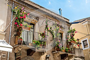 Typical Sicilian balcony in Taormina full of flowers and decorations