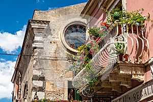 Typical Sicilian balcony in Taormina full of flowers and decorations