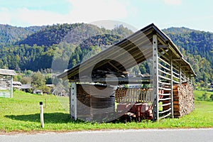 Typical Slovenian Countryside with traditional open sided barn and wood store