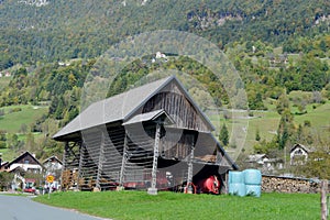 Typical Slovenian Countryside with traditional open sided barn and wood store