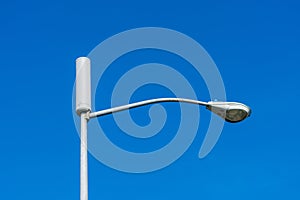 A typical small cell antenna for 5G wireless network installed on a street light pole photo