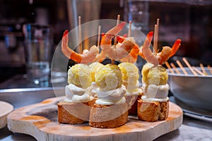 Typical snack in bars of Basque Country and Navarre, pinchos or pinxtos, small slices of bread upon which ingredient or mixture of