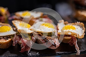Typical snack of Basque Country and Navarre, pinchos or pinxtos served in bar, small slices of bread upon which ingredient or