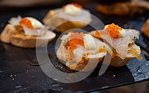 Typical snack of Basque Country and Navarre, pinchos or pinxtos served in bar, small slices of bread upon which ingredient or