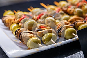 Spanish snacks and street food, baked pie empanadilla with different filling on market in San-Sebastian, Spain