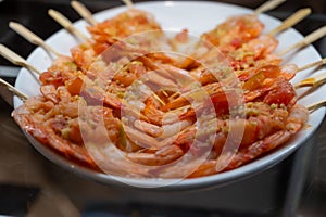 Typical snack of Basque Country, pinchos or pinxtos skewers with small pieces different fish and sea food, served in bar in San-