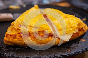 Typical snack of Basque Country, pinchos or pinxtos, small piece of bread with egg omelette, different toppings, served in bar in