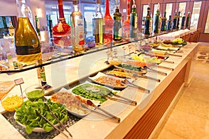 Self service restaurant and barbecue steakhouse with salad table.