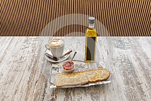 Typical Spanish breakfast of cafe con leche with toasted bread with tomato and olive oil photo