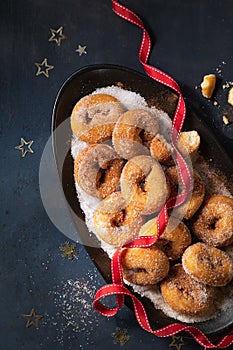 Typical spanish donuts, fried rosquillas with sugar, over dark background with copy space. Christmas, new year holidays background