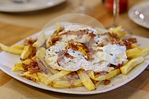 Typical Spanish food, fried eggs, chips and ham. Scrambled eggs photo