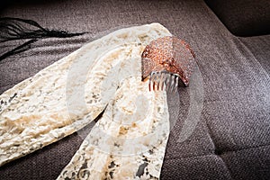 Typical spanish mantilla and comb on sofa photo