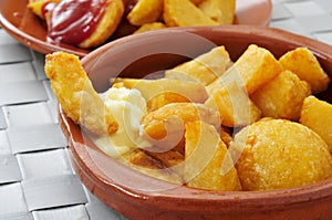 Typical spanish patatas bravas, fried potatoes with a hot sauce