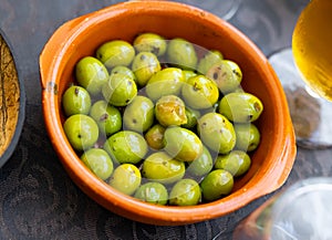 Typical spanish tapas is green pickled olives with pits
