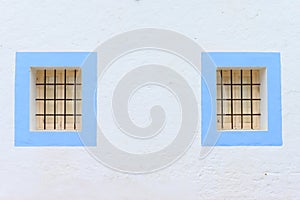 Typical Spanish townhouse with blue frames around windows in Santa Gertrudis Ibiza