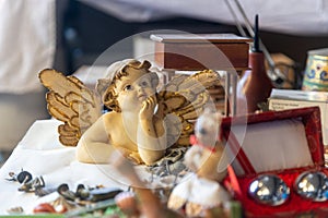Typical stall on Els Encants flea market at Placa de les Gloriesa. Wooden angel, petong balls on the table photo