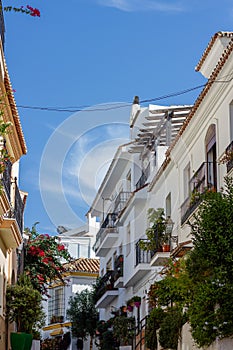 A typical street in old city Estepona with colorful flower pots. Estepona, Andalusia, Spain