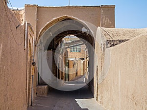 Typical street of the old town of Kashan, iran, with its typical clay walls, ancient gates and clay buildings. Kashan is the main