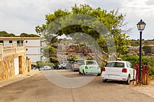 Typical street with parked cars in Cala Figuera Mallorca Spain