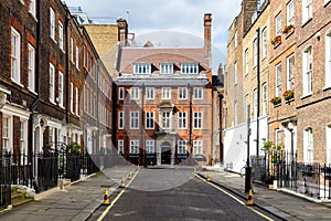 Typical street scene in the central London district with familiar architecture facades to urban housing.