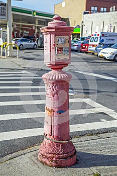 typical street scene with old victorian fire and police emergency telephone