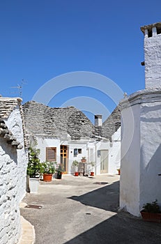 Typical street with white Trulli houses. Alberobello, Italy