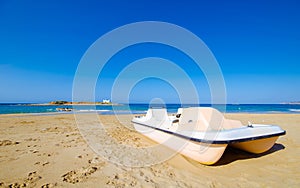 Typical summer image of an amazing pictorial view of a sandy beach and an old white church in a small isl photo