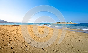 Typical summer image of an amazing pictorial view of a sandy beach and an old white church in a small isl photo