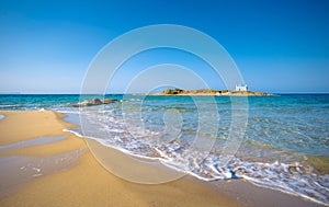 Typical summer image of an amazing pictorial view of a sandy beach and an old white church in a small isl photo