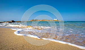 Typical summer image of an amazing pictorial view of a sandy beach and an old white church in a small isl photo