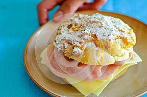 Typical sweet bread from Portugal Pao de Deus, God`s bread, stuffed with ham and cheese photo