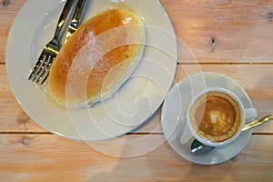 Typical sweet and dessert of Bilbao called butter bun next to a cup of espresso coffee photo