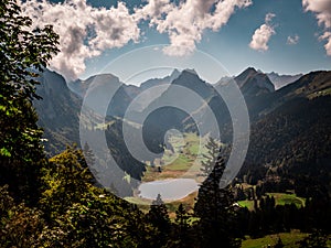 Typical swiss mountain scenery with mountain lake during sunny summer day