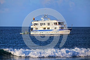 Typical tourist yacht anchored at Suarez Point at Espanola Island, Galapagos National park, Ecuador