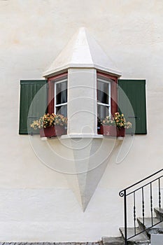 Typical traditional house windows style in triangle form, Alp Engadine, Switzerland