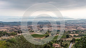 Typical Tuscan landscape with hills and cypresses in the very early morning near Montaione