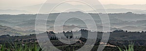 Typical Tuscan landscape with hills and cypresses in the very early morning near Montaione