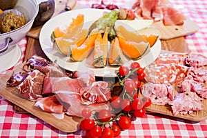 Typical Tuscany cuisine with prosciutto, cheese and fruit.