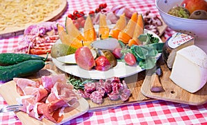 Typical Tuscany cuisine with prosciutto and fruit. photo